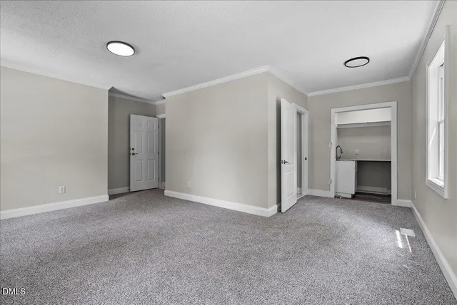 a view of empty room with a fireplace