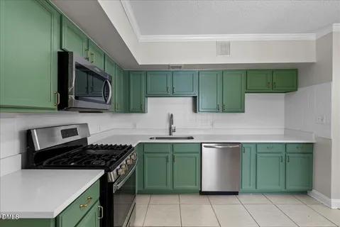 a kitchen with a stove sink and cabinets