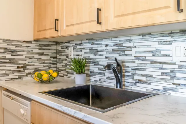 a kitchen with a sink and a counter top space