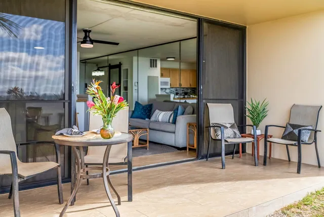 a living room with furniture and a potted plant