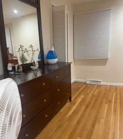 a room with a bed and a dresser