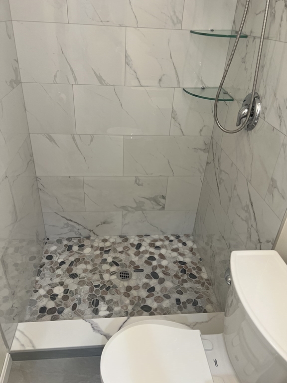 50 Main Street Medway, MA 02053 - Photo 16 of 23 a bathroom with a toilet and a shower