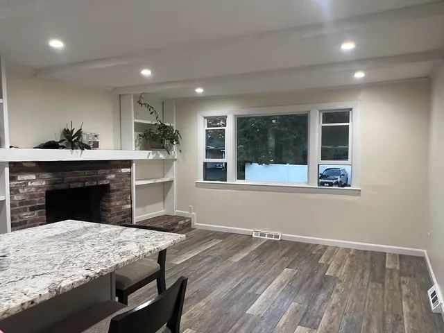 a view of wooden floor and a fireplace in a room