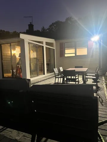 a front view of a house with outdoor seating