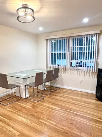 a view of a room with a table and chairs