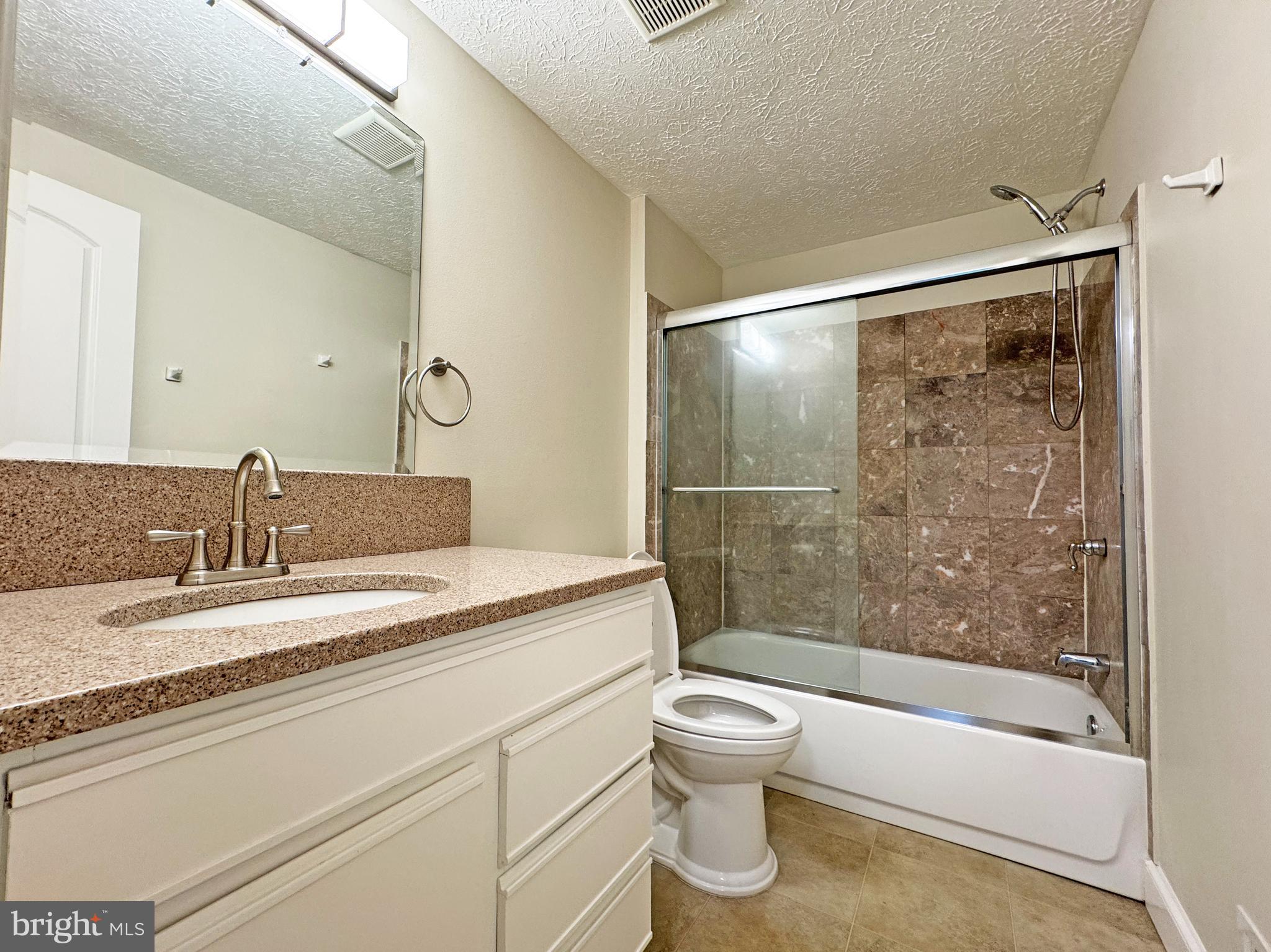 357 Council Oak Drive Severn, MD 21144 - Photo 15 of 37 a bathroom with a granite countertop sink toilet and shower