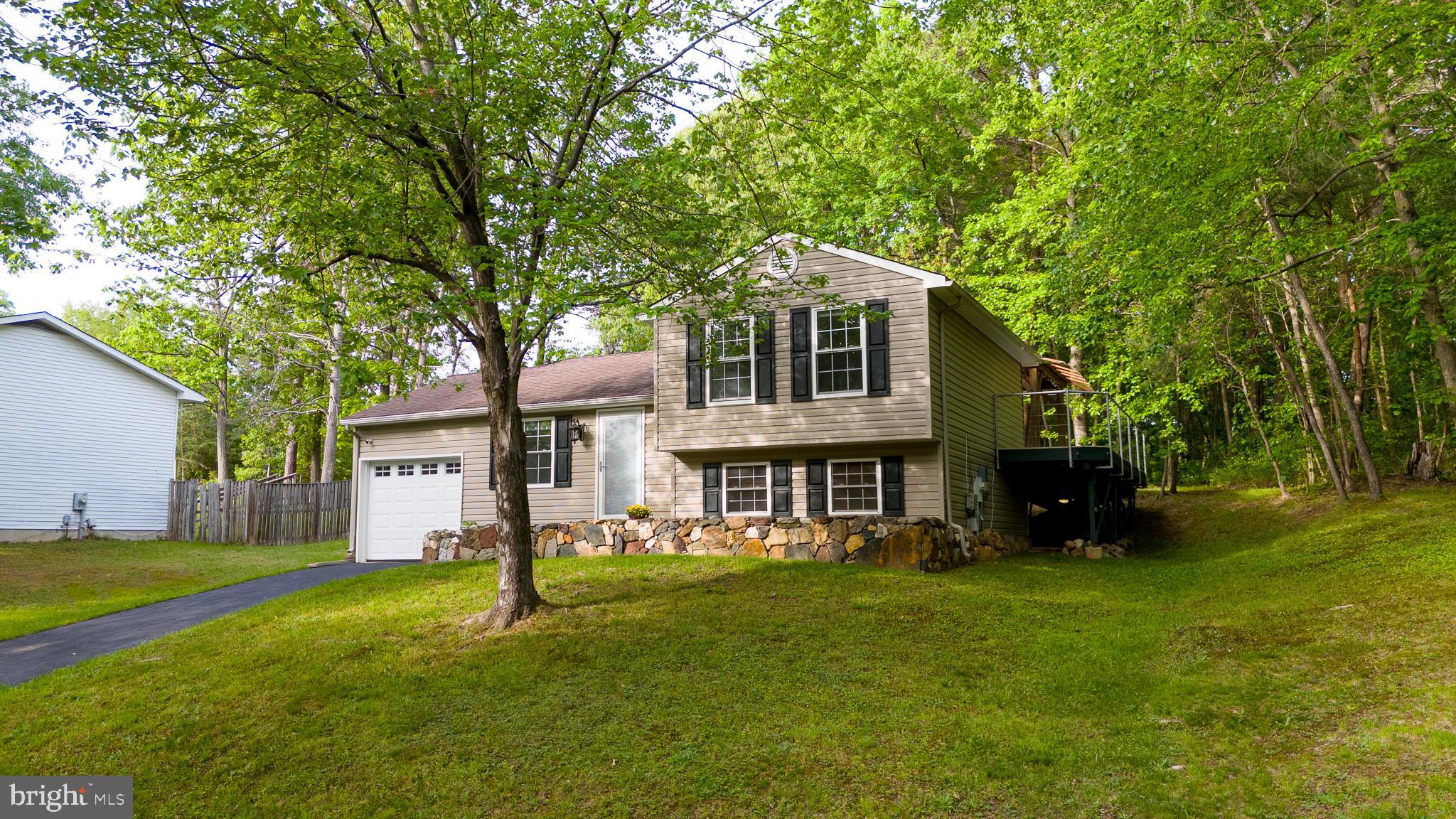 357 Council Oak Drive Severn, MD 21144 - Photo 5 of 37 a front view of a house with a garden