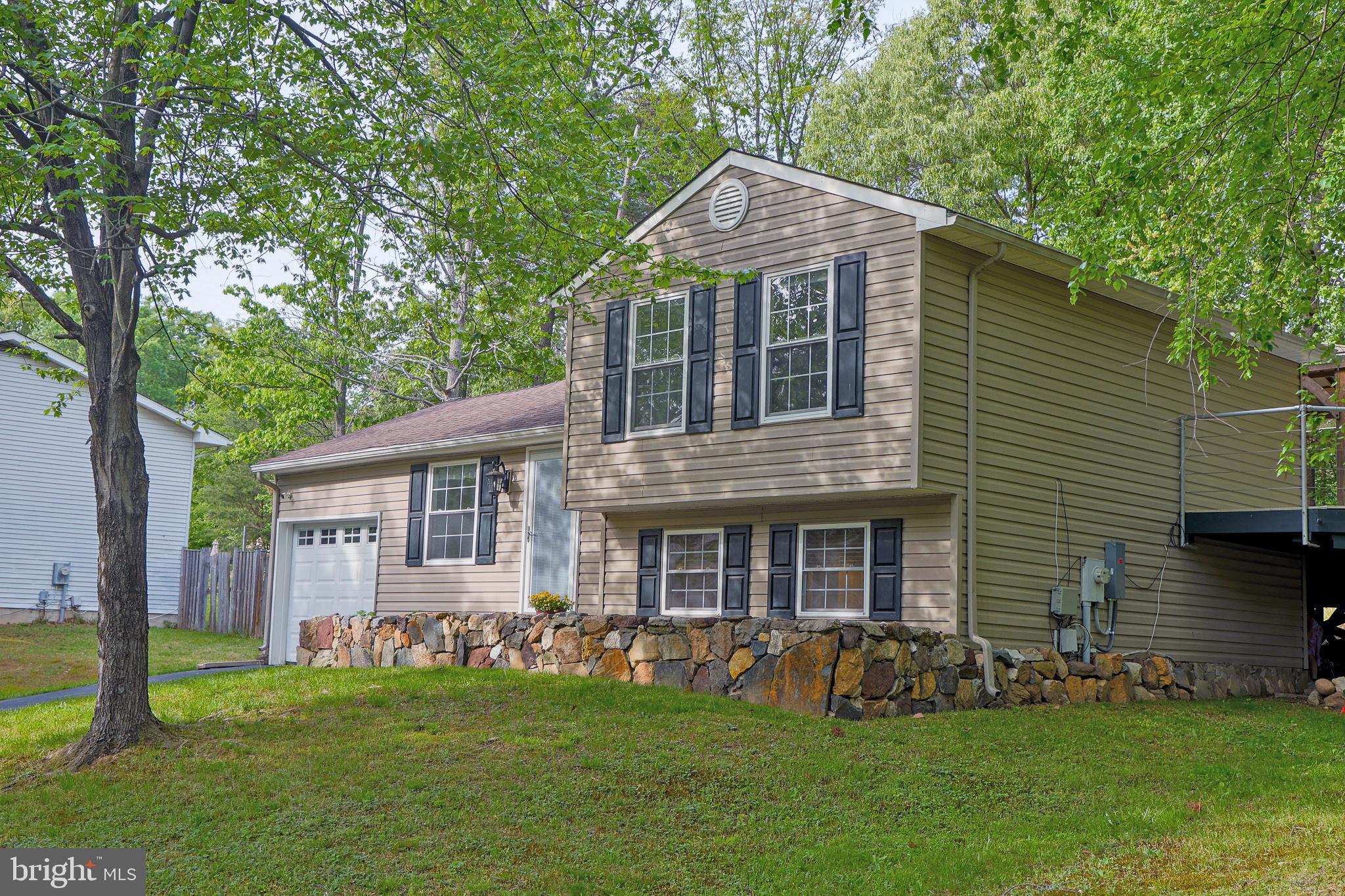 357 Council Oak Drive Severn, MD 21144 - Photo 6 of 37 a front view of a house with a garden