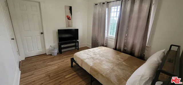 a bedroom with a bed and a mirror