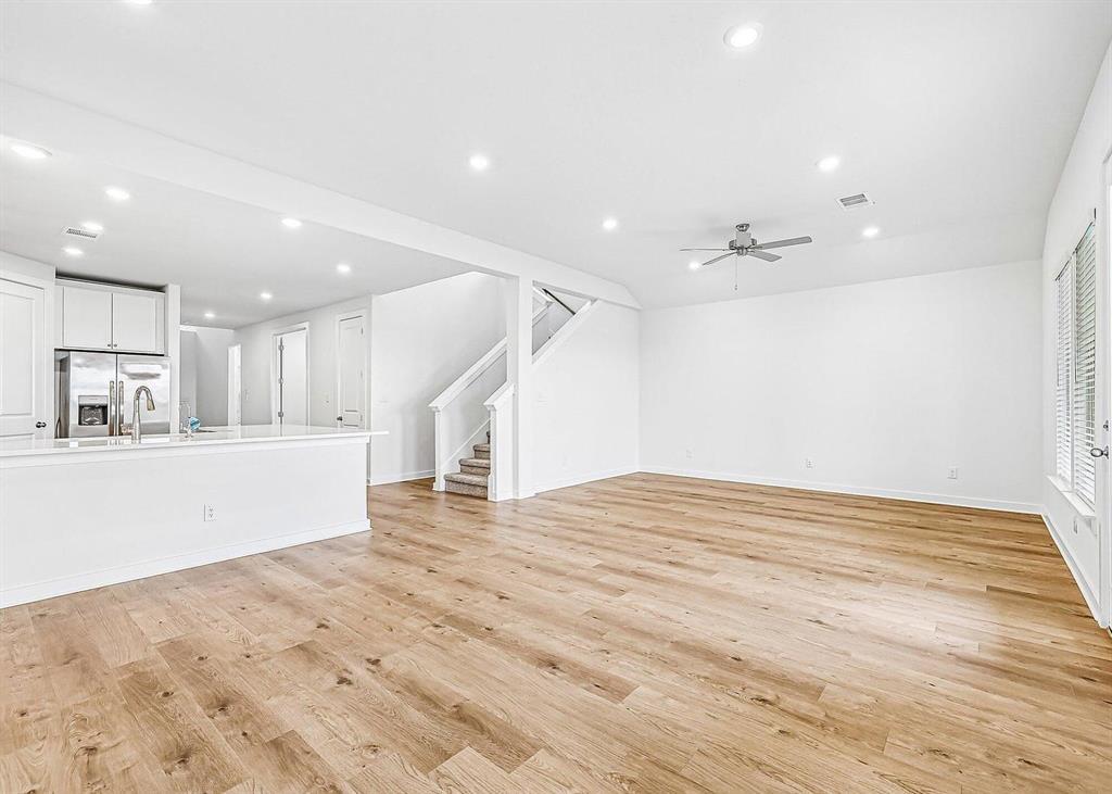 408 Brandywine Road Hutto, TX 78634 - Photo 9 of 13 Warm wood flooring and clean lines define this inviting, open-concept main floor living space.