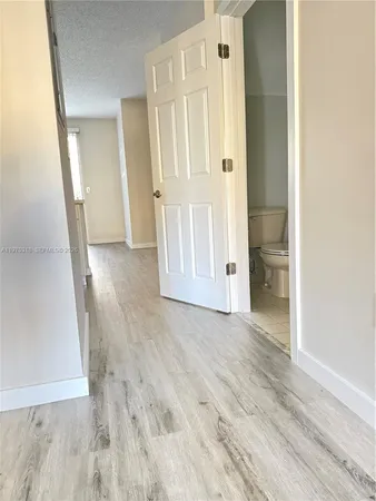 an empty room with wooden floor