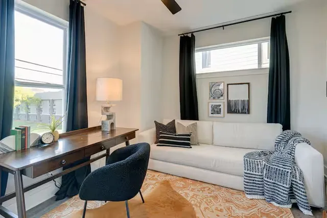 a aerial view of a wooden table and chairs in the patio