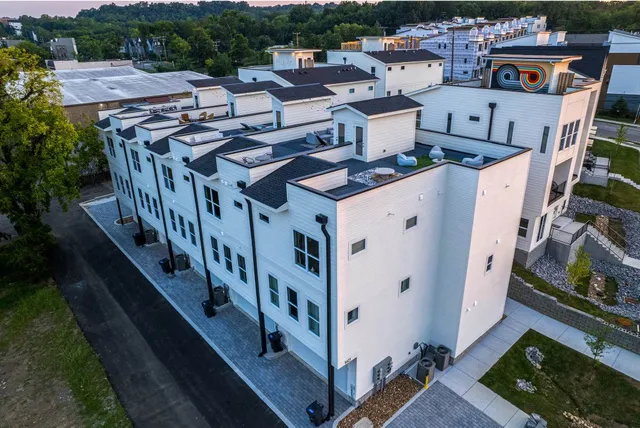 an aerial view of multiple houses with yard