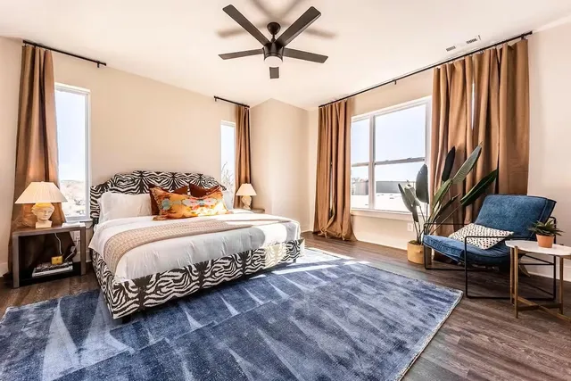 a bedroom with bed and wooden floor