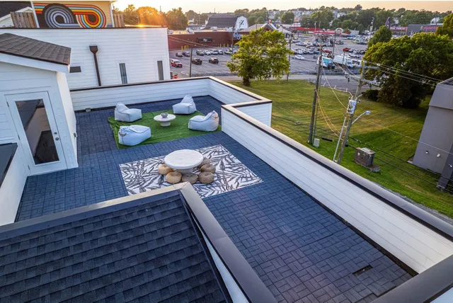 an aerial view of multiple houses with yard