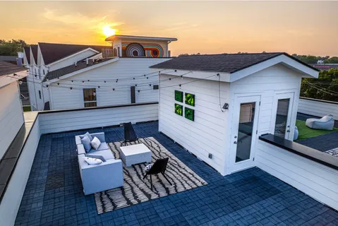 a balcony with furniture and a potted plant