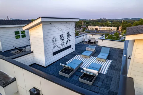 a living room with furniture and a potted plant