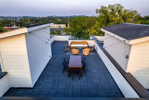 a living room with furniture ceiling fan and a window