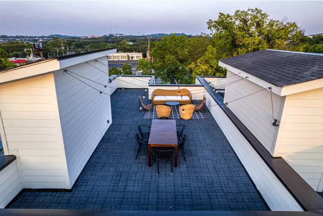a living room with furniture ceiling fan and a window