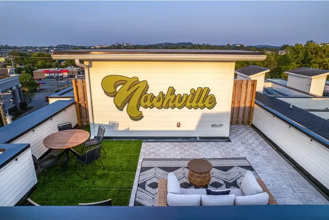 an aerial view of a house with roof deck