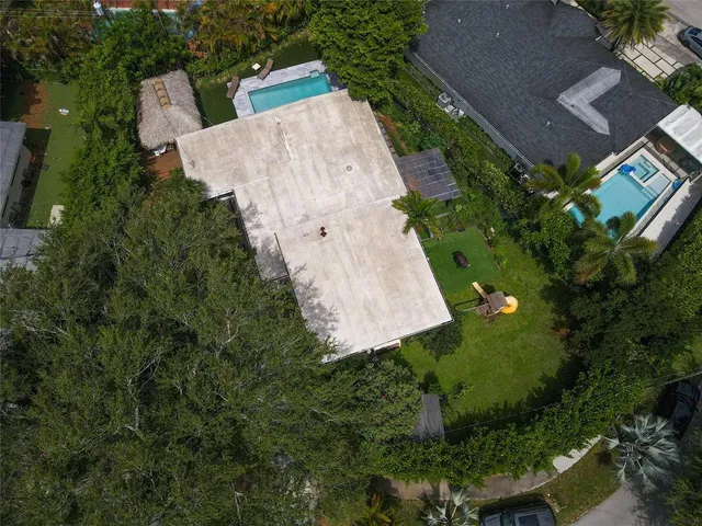 an aerial view of a house with a yard and garden
