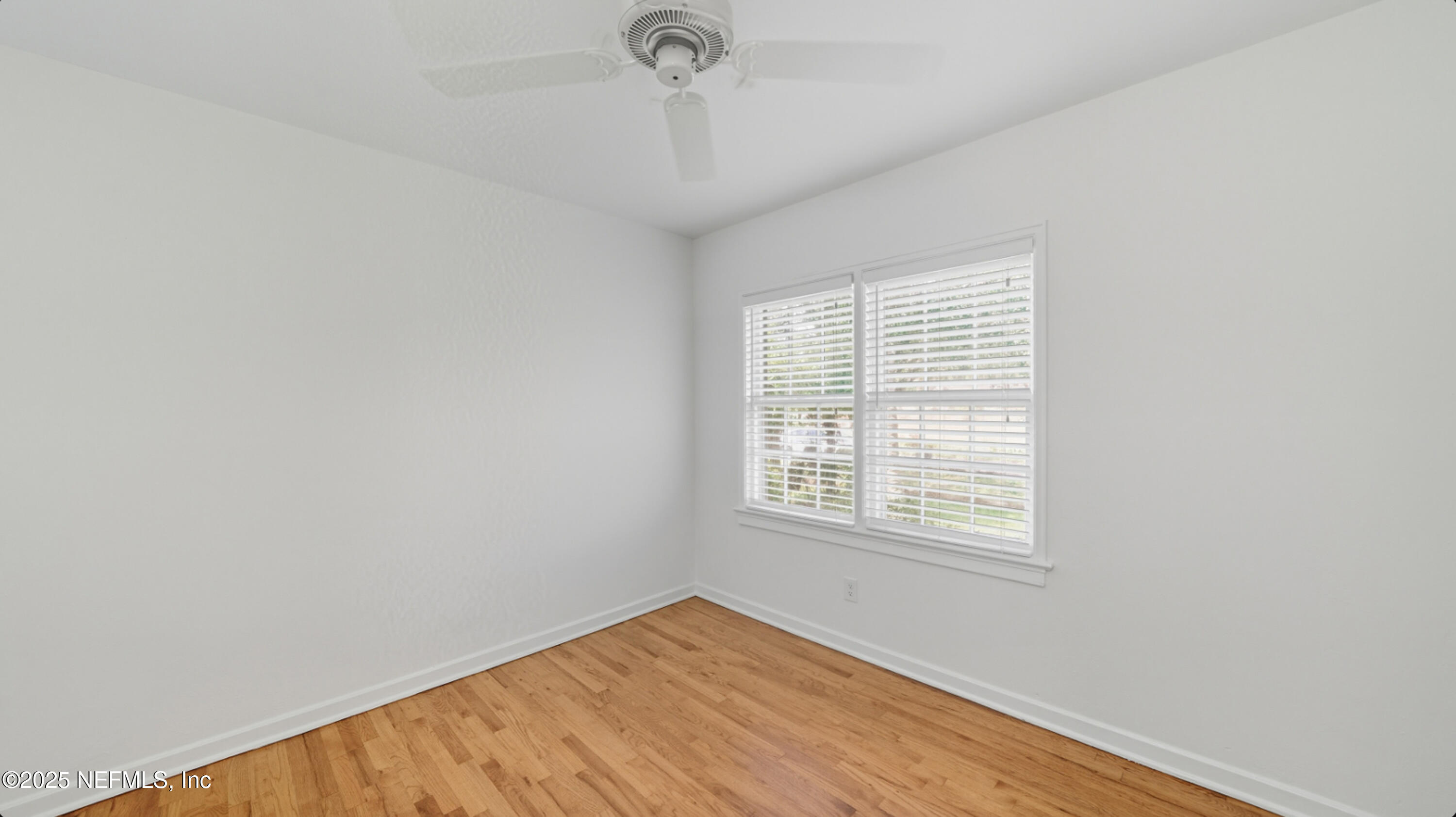 2604 Bayview Road Jacksonville, FL 32210 - Photo 15 of 31 a view of an empty room with wooden floor and a window