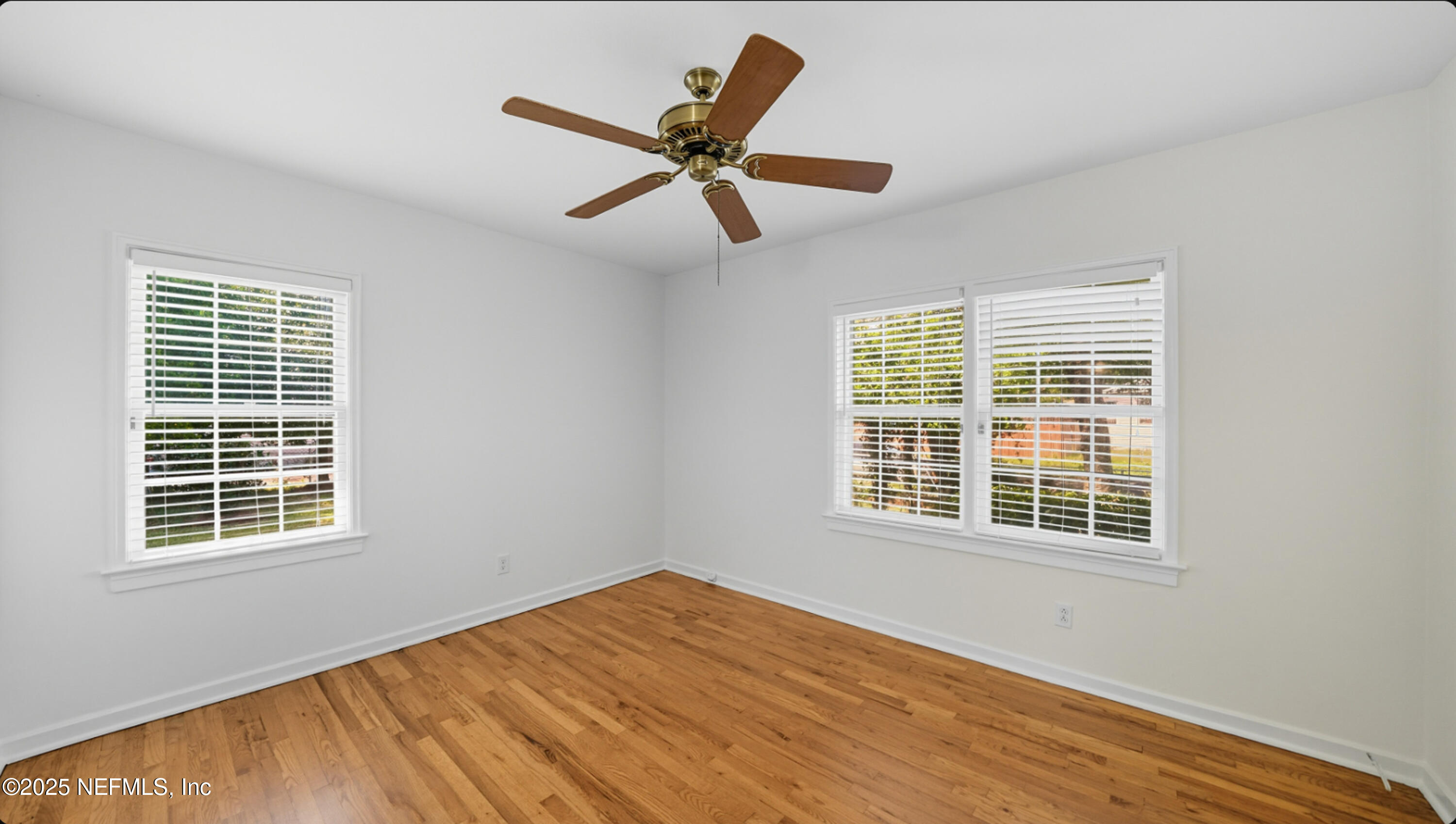 2604 Bayview Road Jacksonville, FL 32210 - Photo 18 of 31 a view of an empty room with wooden floor and a window