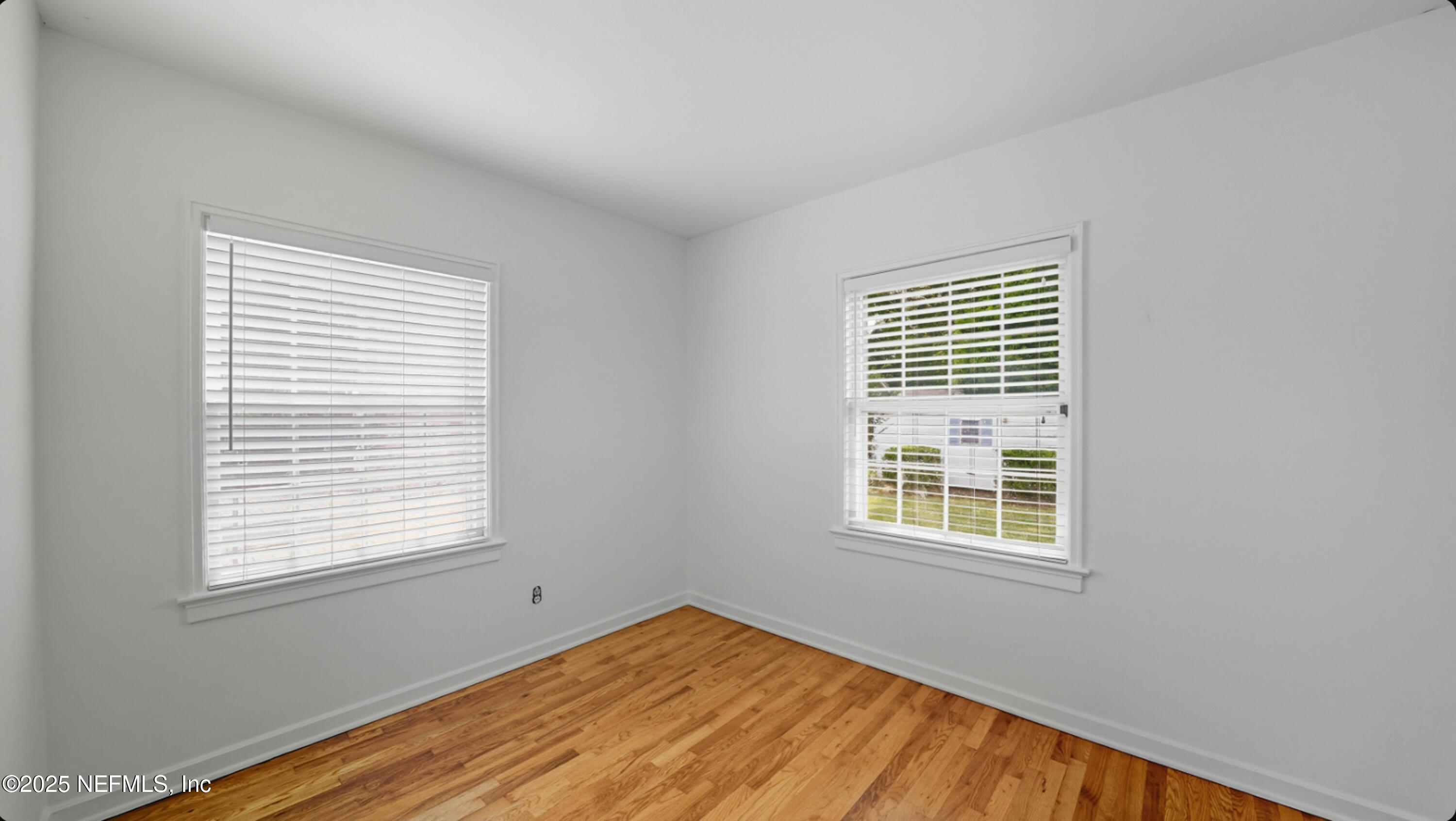 2604 Bayview Road Jacksonville, FL 32210 - Photo 20 of 31 a view of an empty room with wooden floor and a window