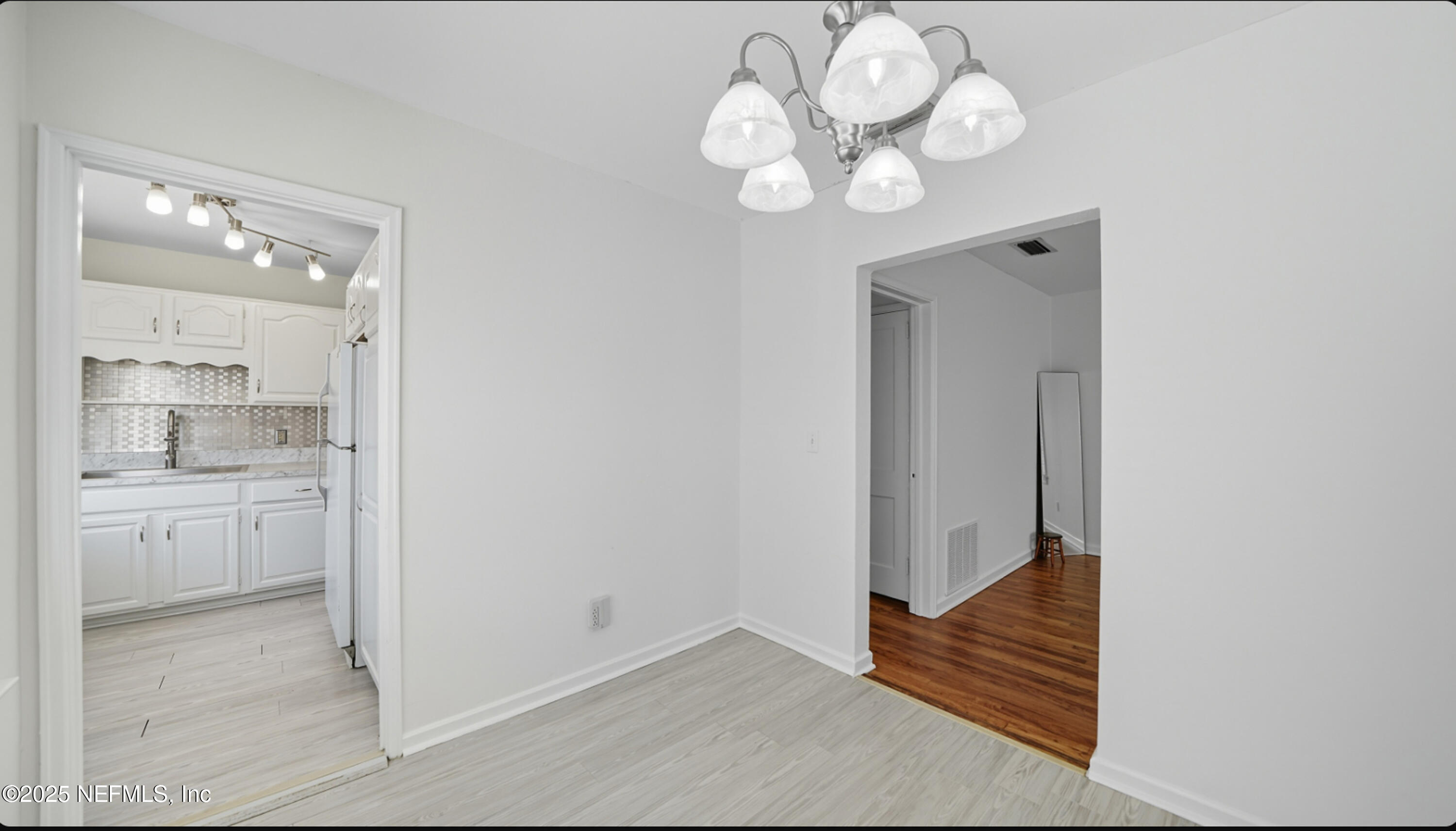2604 Bayview Road Jacksonville, FL 32210 - Photo 8 of 31 a view of a hallway with wooden floor and a kitchen