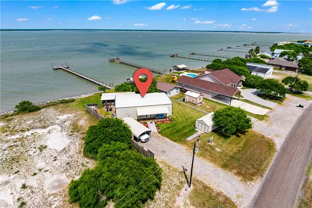 a view of a lake with lawn chairs