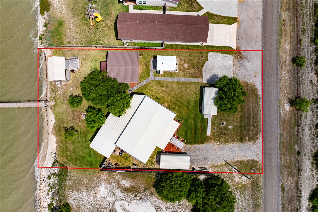 1356 Neubauer Point Road Riviera, TX 78379 - Photo 2 of 40 an aerial view of a house with a yard and lake view