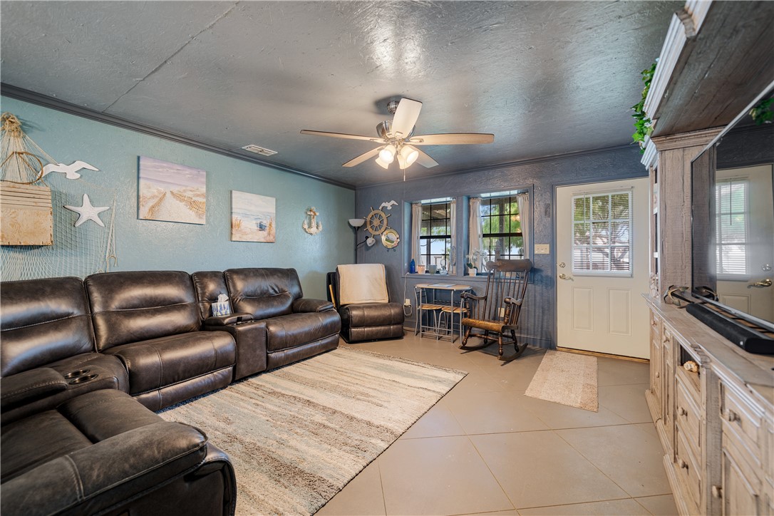 1356 Neubauer Point Road Riviera, TX 78379 - Photo 21 of 40 a living room with furniture and a flat screen tv with kitchen view