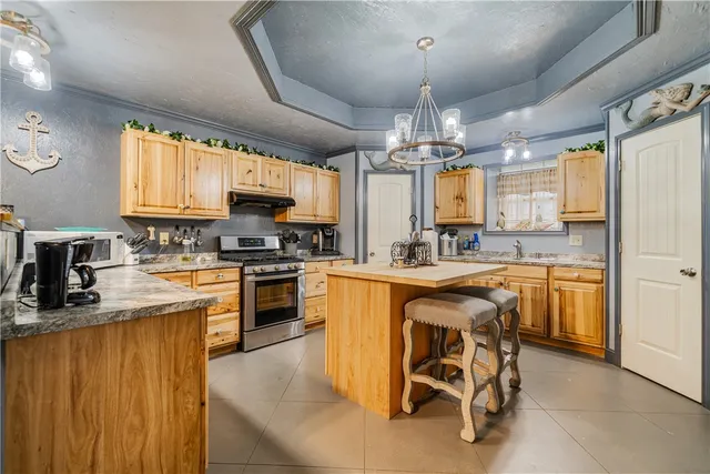 a kitchen with stainless steel appliances granite countertop a stove microwave and refrigerator