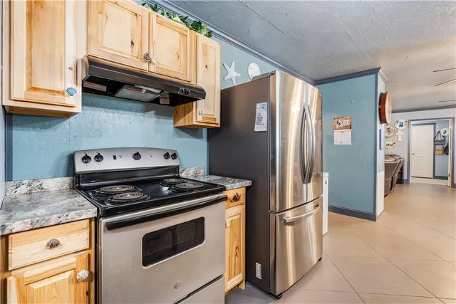 a kitchen with stainless steel appliances a refrigerator and a refrigerator