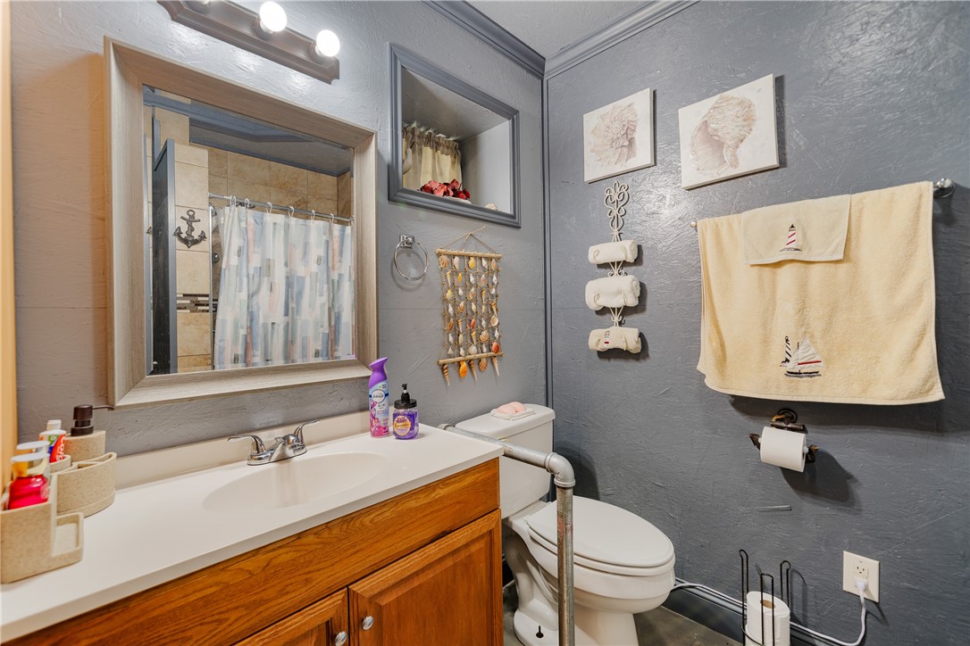 1356 Neubauer Point Road Riviera, TX 78379 - Photo 29 of 40 a bathroom with a sink toilet and a mirror