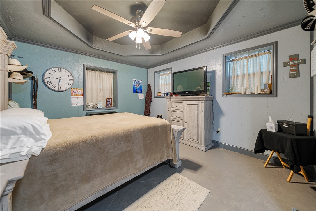 1356 Neubauer Point Road Riviera, TX 78379 - Photo 32 of 40 a bedroom with a bed a chair and a flat tv screen