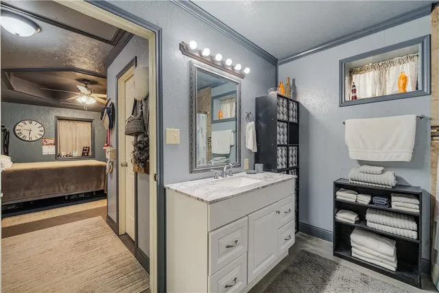 a bathroom with a shower a sink and a mirror