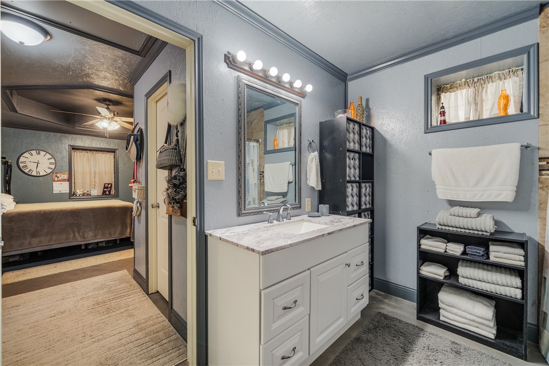 1356 Neubauer Point Road Riviera, TX 78379 - Photo 34 of 40 a en suite bathroom with a double vanity sink and a mirror