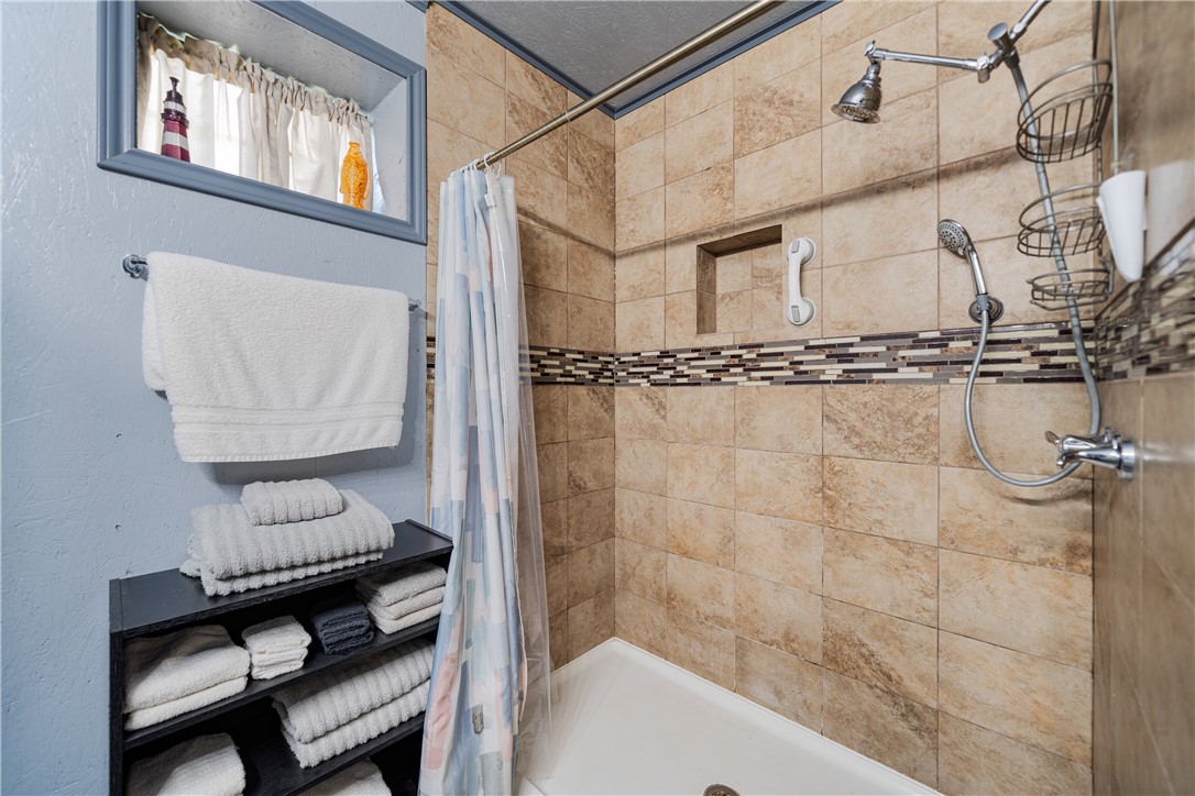 1356 Neubauer Point Road Riviera, TX 78379 - Photo 36 of 40 a bathroom with a shower a sink and a mirror