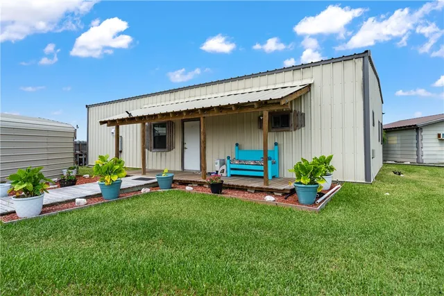 a view of a house with backyard and porch