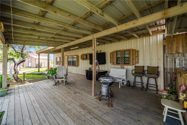 a view of a porch with wooden floor