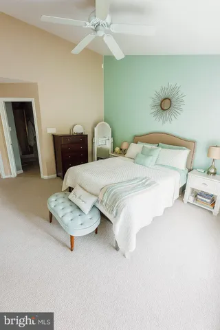 a bedroom with bed and a chandelier