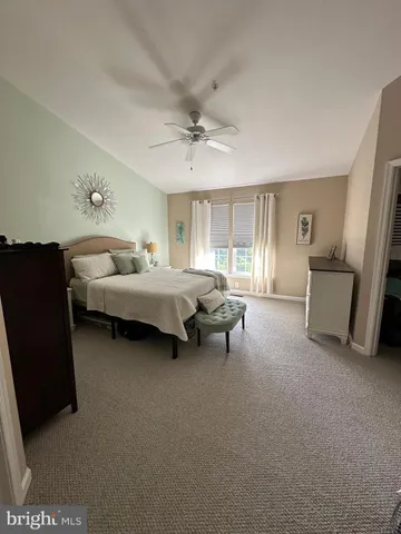 a spacious bedroom with a bed and a chandelier