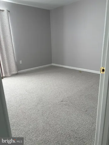 a bathroom with a toilet and a shower curtain