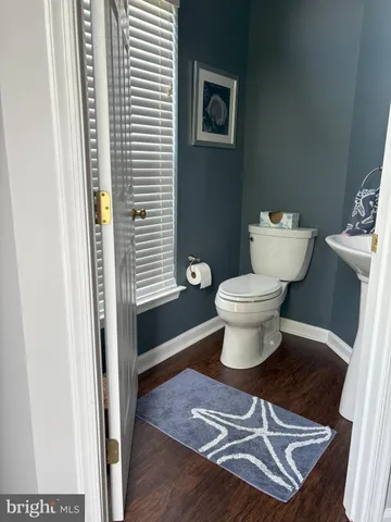 a kitchen with a table chairs sink and cabinets