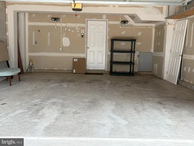 a front view of a house with a parking space