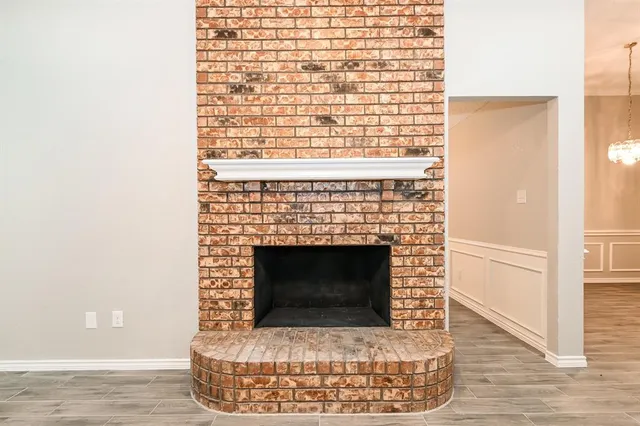 a living room with a fireplace and a wooden floor