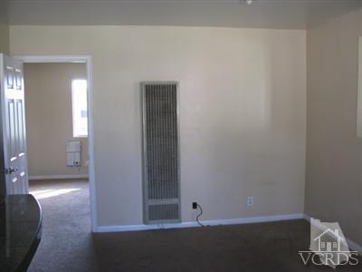 1925 Ginger Street, Unit 225 Oxnard, CA 93036 - Photo 3 of 5 an empty room with wooden floor and windows