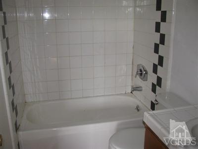 1925 Ginger Street, Unit 225 Oxnard, CA 93036 - Photo 4 of 5 a bathroom with a bathtub and a shower