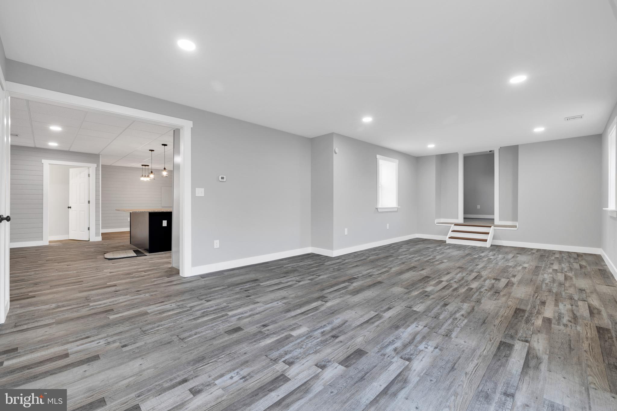 119 Heidelberg Avenue Reading, PA 19606 - Photo 14 of 36 a view of an empty room with wooden floor and a kitchen